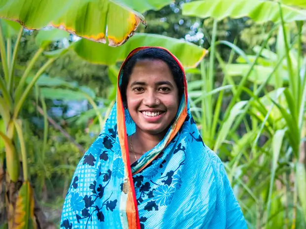 Shukla smiles in her garden in Bangladesh